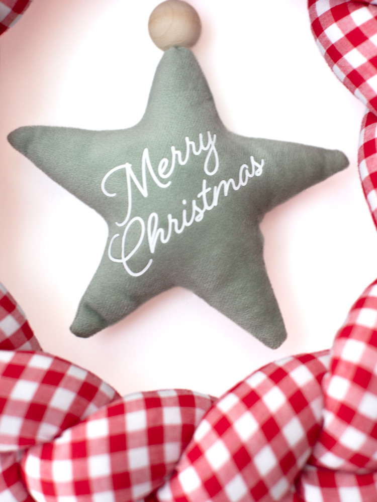 Sage green hanging Christmas star with white Merry Christmas lettering