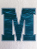 Close-up of the ocean print within the ‘M’, showcasing rich blue tones and soft water-like movement