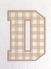 Close-up of the gingham print within the ‘D’, showcasing soft tan tones and a classic check pattern