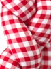 Close-up of red and white gingham fabric on handmade Christmas wreath