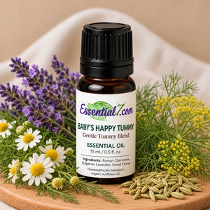 Essential7 Baby’s Happy Tummy essential oil blend in an amber bottle, surrounded by Roman chamomile flowers, Bulgarian lavender, and sweet fennel.