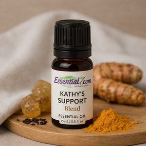 Kathy’s Support Blend essential oil by Essential7 with turmeric and black cumin on wooden surface