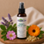 Mama’s Comfort Spray by Essential7 in an amber spray bottle surrounded by lavender, calendula, rosehip and frankincense botanicals for gentle outdoor skin support.