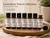 Essential7 GastroEase Travel Collection featuring seven TSA-friendly 5 mL amber essential oil bottles — Kate’s Happy Tummy, Sustainable Patchouli, Sustainable Turmeric, Gastro, Nausea, Relax and Release, and Kathy’s Sleep Easy — with new inner travel inserts to help reduce leaks on the go.