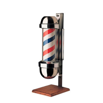 Studio product shot of the William Marvy No. 410 Barber Pole On-Stand, designed for window or counter display. The unit features classic rotating red, white, and blue stripes encased in polished stainless steel and is mounted on a solid American Walnut base.