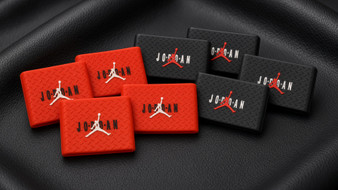 Red and black 5-pack silicone clipper grips on a black barber station