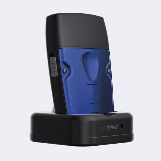 Rear view of the BaBylissPRO® LO-PROFX Compact Foil Shaver docked in its black charging stand, highlighting the blue metal housing and ergonomic grip.