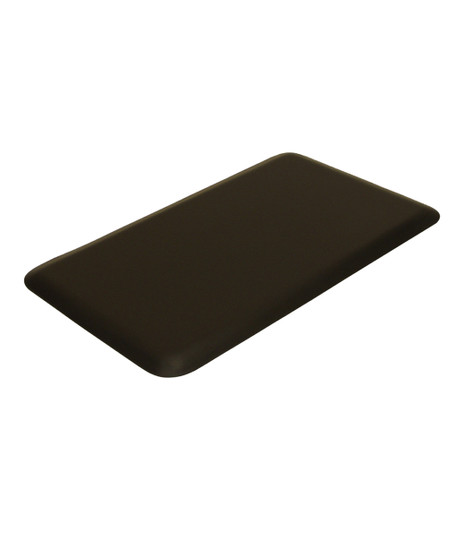 Angled view of the 1.5' x 2.5' Super Soft Shampoo Mat, featuring a comfortable 1/2-inch thick anti-fatigue core and a smooth black surface designed for salon wash stations.