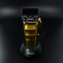 Front view of the gold Saber 2 cordless hair clipper in its black charging stand, showing the detailed DLC Echo blade.