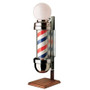 Studio product shot of the William Marvy No. 410 Two Light Barber Pole On-Stand, featuring an illuminated white opal globe on top for extra visibility. The unit is mounted on a solid American Walnut base and displays the classic rotating red, white, and blue stripes within a polished stainless steel housing.
