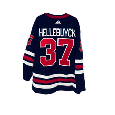 Connor Hellebuyck Winnipeg Jets Unsigned Reverse Retro Jersey In Net  Photograph