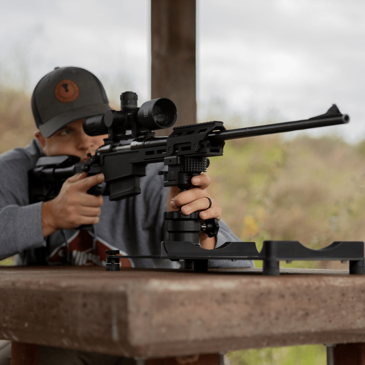 man shooting a rifle that is on UD launch pad