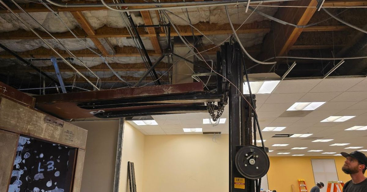 Bank vault installation work near an open ceiling