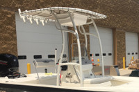 Zoomed in photo show closer detail of a white SG600 folding t-top, e-box for storage, 7 rod holder and white Sunbrella canopy.