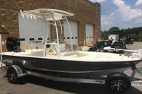 Customer's boat with a white SG600 folding t-top, e-box for storage, 7 rod holder and white Sunbrella canopy.
