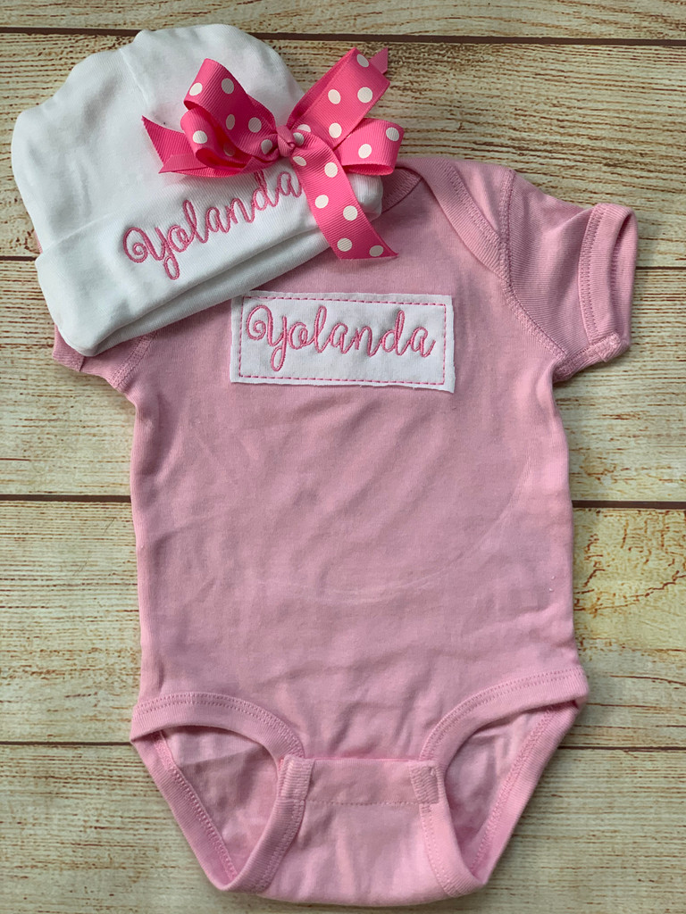 Our Patch onesie and hat set for girls.  Add that bow to make it super sweet!    Wicked Stitches Gifts.
