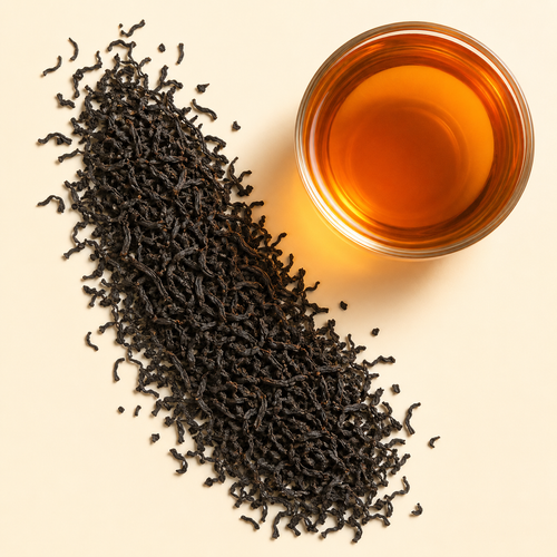 Ceylon Sonata loose leaf black tea with a cup of bright amber brewed tea on a warm cream background.