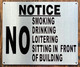 NO SMOKING DRINKING LOITERING SITTING IN FRONT OF BUILDING  AGE