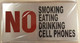 NO SMOKING EATING DRINKING CELL PHONES SIGN