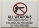 SIGN ALL WEAPONS INCLUDING CONCEALED FIREARMS ARE PROHIBITED ON THESE PREMISES  - PURE WHITE (ALUMINUM S)