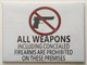 ALL WEAPONS INCLUDING CONCEALED FIREARMS ARE PROHIBITED ON THESE PREMISES  - PURE WHITE (ALUMINUM S)