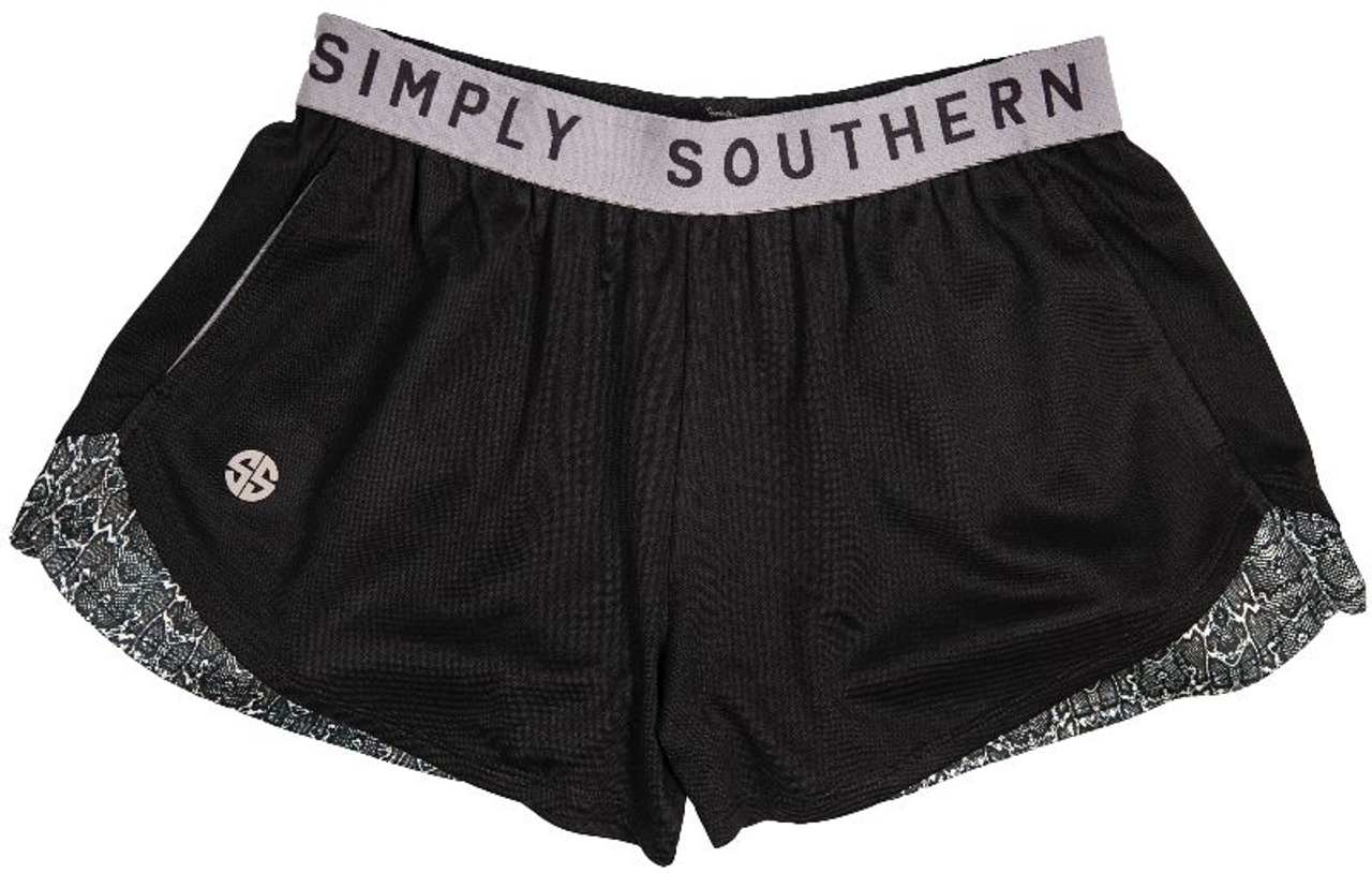 Black cheer shorts with gray thick elastic Simply Southern waistband, reflective SS patch on the front, and two front hip pockets. Features snake print side hem panels. 0122-CHEERSHORT-SNAKE