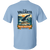 Back print of light blue whale watching t-shirt featuring breaching humpback whale and coastal illustration.