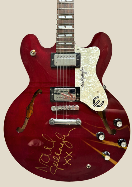 Own a piece of Oasis history — a pristine Epiphone 335 Cherry Supernova Signature Series guitar, signed by Noel Gallagher during his 1998 Australian tour. Never played, encased, and authenticated. Exclusive to Mall Music.