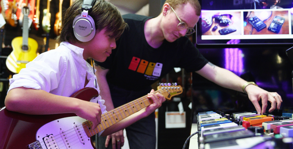 Roland Store in Store - Pip Assisting young male customer with guitar