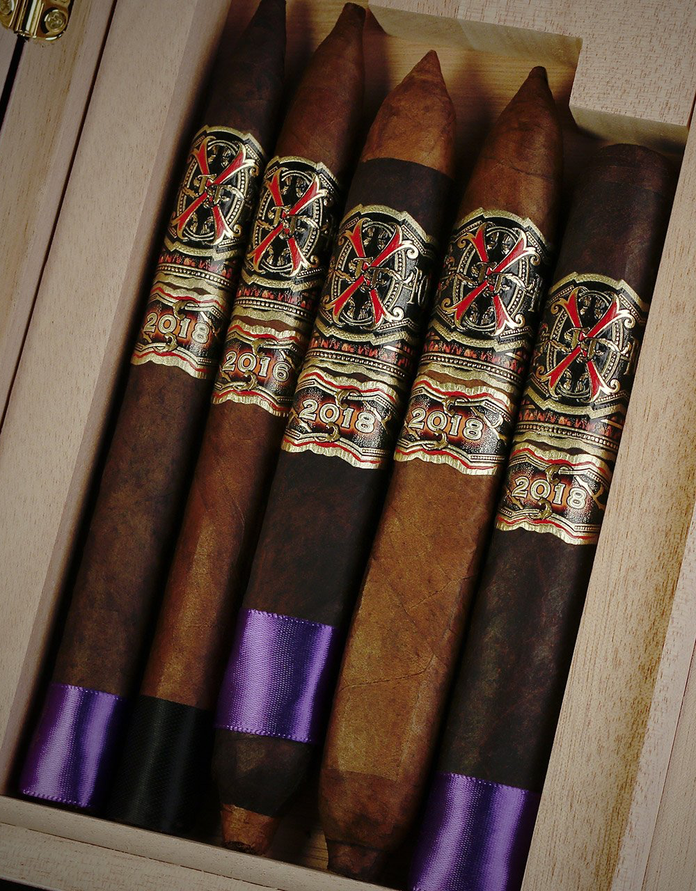 Five distinct vitolas offer varied smoking profiles, from the torpedo-shaped Opus X Rare Black to the robust Opus X Tauros the Bull Maduro.