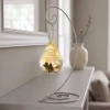 Merry Christmas in Heaven personalized glass teardrop memorial ornament shown on optional display stand