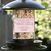 Close-up of the Sister memorial bird feeder showing the floral remembrance panel and personalized name and dates.