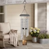 Close-up of the wind chime sail engraved with the Our Broken Chain memorial poem, name, and dates