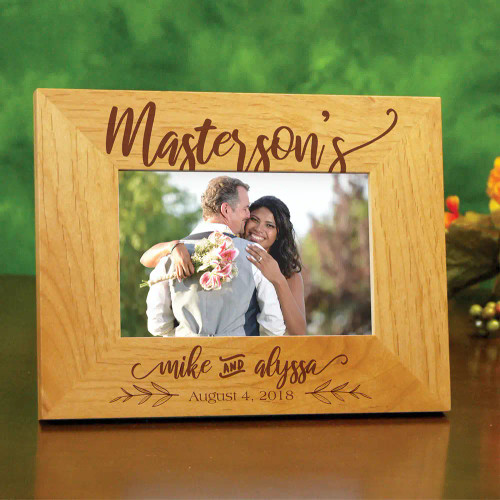 Happy couple photo frame is personalized with name and wedding date.