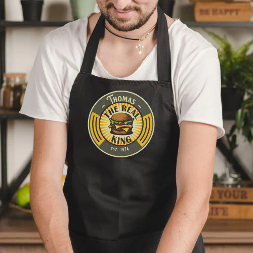 The Real King of the Burger personalized apron has his name and birth year.