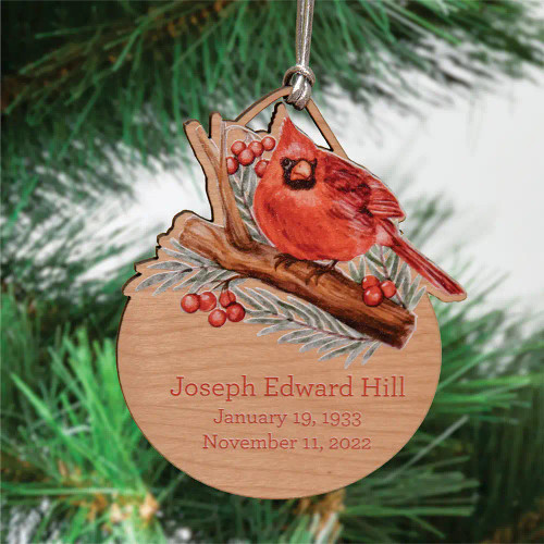 Cardinal memory ornament is made of alder wood and personalized with loved ones name and dates