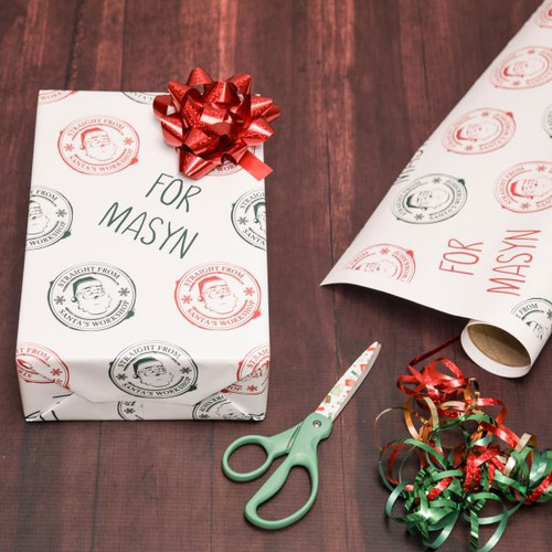 Personalized Christmas gift wrap for kids has their name printed on it