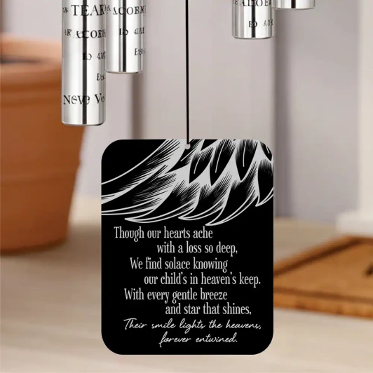 Our Angel Child Memorial Chime sail featuring angel wing design and poem "We find solace knowing our child's in heaven's keep" — personalized with child's name and dates