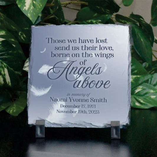 Personalized memorial plaque features loved one's name and dates.