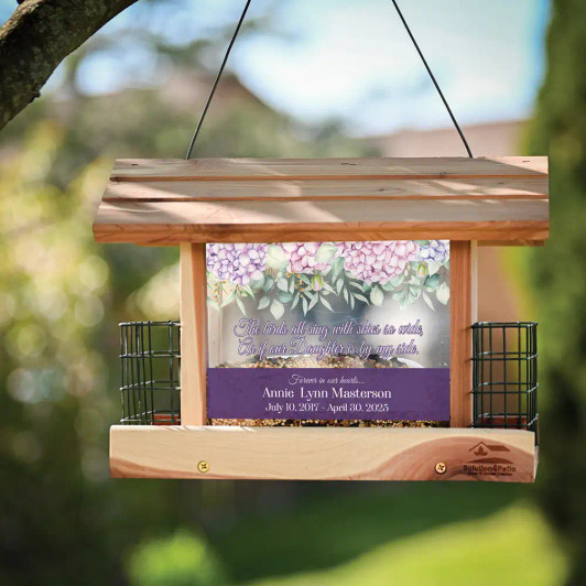 Personalized memorial bird feeder is made of cedar and has daughter's name and dates along with a short verse printed on the panels. Personalized memorial bird feeder is made of cedar and has daughter's name and dates along with a short verse printed on the panels.