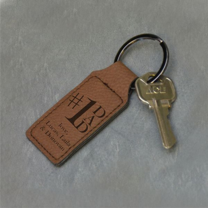 #1 Dad Personalized Keychain in dark brown is engraved with short message