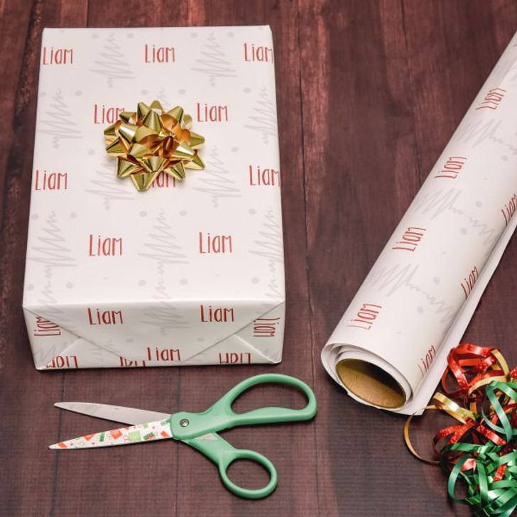 Personalized Christmas gift wrap features of a repeating christmas tree patter and name