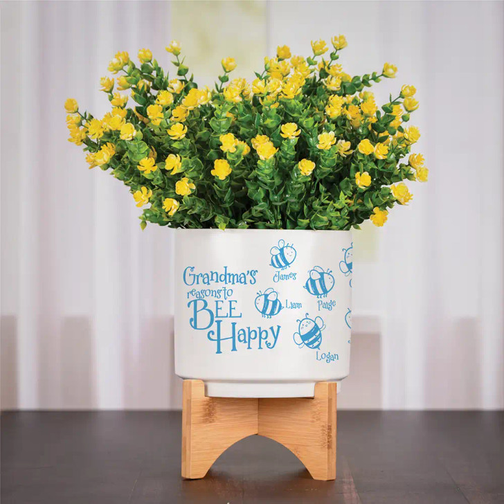 Bee Happy personalized flower pot is personalilzed with a name or nickname and then bees associated with each child. Shown with Caribbean blue paint fill