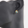 9ct Gold Blue Topaz and Diamond Criss-Cross Stud Earrings - Worn View