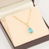 9ct Gold Blue Topaz Pendant with Chain - In Box