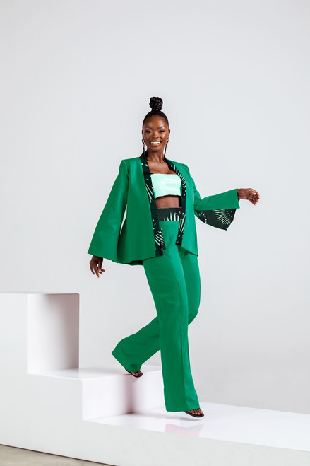 Model wearing Pump Suit Ensemble - green blazer and pants with green African wax print