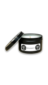 round black metal tin with lid containing white candle wax