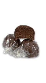 a pyramid of chocolate truffles, two wrapped round truffles on the bottom and an unwrapped half of a truffle on top showing the chocolate fudge center