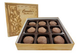 An open gold box with a divided insert and nine individual chocolate treats.