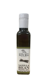 Rectangular glass bottle with a white and green label portraying a picture of vanilla sticks with the words "Vamilla Bean Olive Oil".